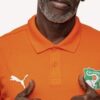 Siramana Dembélé en polo orange de la sélection ivoirienne